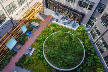 An aerial view of an office building with a green courtyard